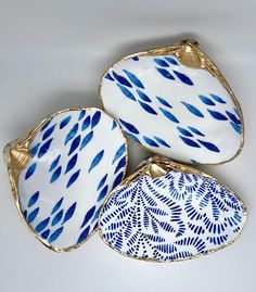 three blue and white dishes sitting on top of each other