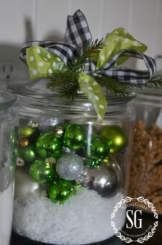 a glass jar filled with green and silver ornaments