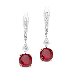 Perfect your attire with these stylish red ruby and diamond earrings. Crafted in 18K white and rose gold, each eye-catching design features a striking cushion-cut red ruby in a rose gold cat claw four-prong setting, topped by a round diamond hanging from a sparkling post. Radiant with 4ct. t.w. these spectacular drops suspend from English lock backs.
1.25 carat cushion cut natural red ruby
1.25 cushion-cut natural red ruby -
0.50-carat shield cut diamonds
0.35 carat pave diamond s Luxury Lab-created Ruby Earrings For Gift, Luxury Ruby Latkans Earrings, Luxury Diamond Earrings With Prong Setting, Classic Red Diamond Earrings With Accents, Luxury Red Brilliant Cut Earrings, Classic Red Diamond Earrings With Brilliant Cut, Luxury Red Diamond Earrings, Luxury Ruby Earrings With Prong Setting, Formal Ruby Gemstone Diamond Earrings