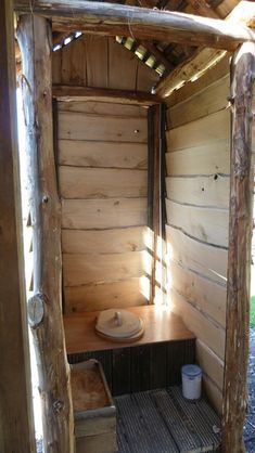 the inside of a small cabin with wood walls