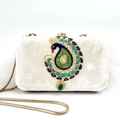 "Stand out wearing this OOAK statement hand embroidered peacock evening clutch bag with genuine moonstone, green onyx and garnets. Is it jewelry or is it a purse? It is both! Each feather is meticulously outlined in sparkly metallic gold tone thread and embellished with semi precious stones for an opulent, dazzling effect. A true gem for a peacock lover. Surprise them with this unique gift. Hand embroidered by master zardozi artisans. The word Zardozi means \"gold thread\". It is a centuries old Bohemian Bags For Festive Formal Occasions, Bohemian Formal Bags For Festive Occasions, Bohemian Evening Bag For Festive Gift, Elegant Festival Bag With Tilla Detailing, Elegant Bags With Tilla For Festivals, Elegant Embroidered Clutch For Celebration, Bohemian Evening Bag With Handwork As Gift, Traditional Openable Shoulder Bag As Gift, Bohemian Festive Clutch For Gifts