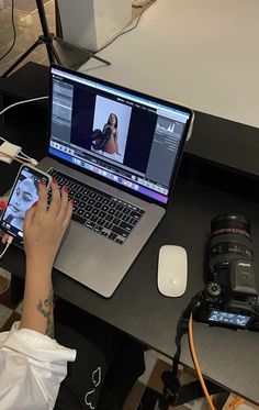 a person sitting at a desk with a laptop and camera