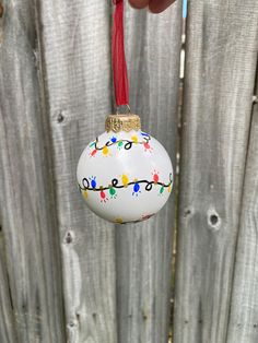 a white ornament hanging from a wooden fence