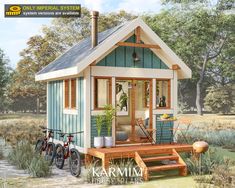 a small blue and white house with two bikes parked in front of the porch area