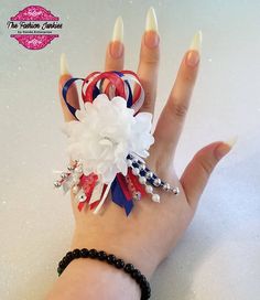 a woman's hand with bracelets and flowers on it