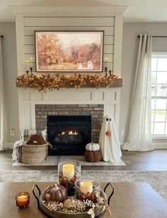 a living room filled with furniture and a fire place in front of a painting on the wall