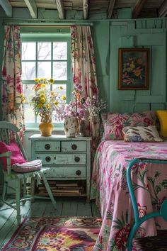 a bed room with a neatly made bed and flowers on the window sill next to it