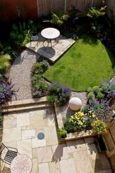 an aerial view of a small backyard garden with seating area and table set up in the middle