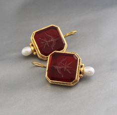 Description Gemstone - Red Glass Material - Brass Gemstone Size - 18 mm Earring Height Including Hoop - 4 cm Earring Width - 2.3 cm Finish - Smooth and high polished with brilliant shine. Note -The earrings are made to order, production day is about 3-5 working days. The one you receive may be slight different from the one in the picture due to handmade nature, but it will be almost same as in the above picture.These pieces are handcrafted from start to finish and have an imperfect handmade look.These earrings are the perfect addition to your collection. Our rings are meant to be classic enough for everyday wear or to give as a bridesmaid gift. You will receive the same piece as in the picture or identical. Since all gemstones are different from each other, I cannot guarantee that the gems Red Pendant Earrings For Anniversary, Red Gemstone Pendant Earrings, Red Cabochon Earrings Perfect For Gifts, Vintage Red Gemstone Earrings, Red Cabochon Earrings For Gift, Red Cabochon Earrings For Wedding, Jewlery Rings, Silver Jewlery, Add Image