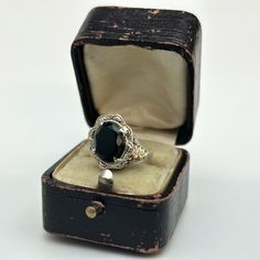 Display ring box not included onyx is epoxyed in the mounting 14k white gold (with rose and green gold detail) weight: 2.4 grams (1.5 dwt) dimensions: height 21 mm, width 17 mm, depth 15 mm Note: stamped 14k  Size 4 1/2 Can be sized by a reputable jeweler. We are new to Etsy, but our home store in Evansville, IN has been in business since 1898. We are a 5th generation family-owned business and have certificates in diamond grading from the GIA (Gemological Institute of America). All items listed Black Victorian Rings With Polished Finish, Black Victorian Gemstone Ring, Victorian Onyx Jewelry For Gift, Victorian Black Enamel 14k Gold Rings, Victorian Silver Onyx Jewelry, Gold Details, Antique Items, Victorian Fashion, Precious Metals