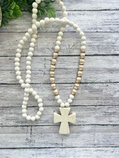 This necklace is one of my shop's best sellers! They easily slip over your head with no clasp and are made with gorgeous natural howlite stones, lightweight white wood beads, and howlite stone statement crosses. They measure approximately 32-33 inches with the cross pendant hanging 2 inches.  These are all hand made and will have slight variations from the photos due to the nature of natural beads, including the cross pendant (see photos). In the listing, you can choose gold or silver accents. White Wooden Beads Necklace For Gift, White Wooden Beads Necklace For Meditation, Adjustable Wooden Beads Jewelry For Blessing, White Spiritual Jewelry With Wooden Beads, Spiritual White Jewelry With Wooden Beads, White Wooden Beads Jewelry For Meditation, White Wooden Beaded Jewelry For Meditation, Adjustable White Cross Necklace, Adjustable White Cross Necklaces