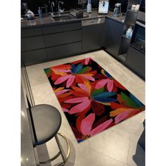 a kitchen area rug with colorful flowers on it