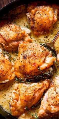 chicken in a skillet with potatoes and herbs on the side, ready to be eaten