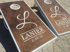 two personalized cornhole game boards sitting on the ground