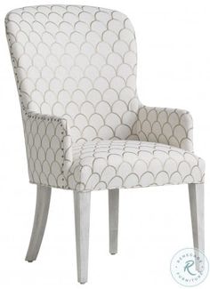 an upholstered chair with white and grey designs on the back, sitting against a white background