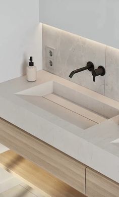 a bathroom sink with two faucets and soap dispensers on the counter