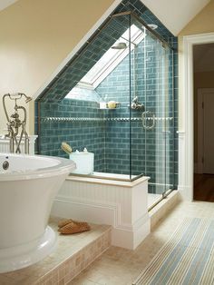 a bathroom with a skylight above it and a bathtub in the middle of the room