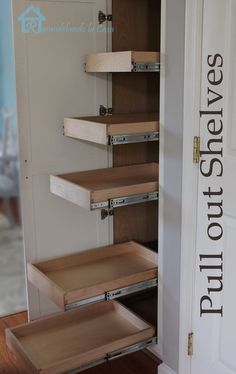 an open pantry door with drawers on each side