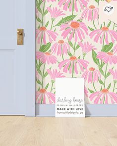 a pink flowered wallpaper is next to a blue door with a sign on it