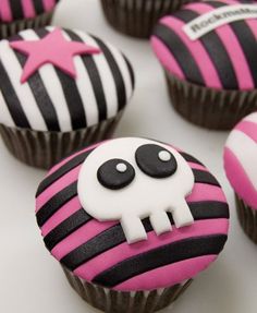 cupcakes decorated with black and pink frosting