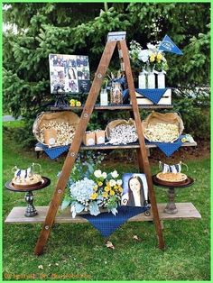 an outdoor dessert table with blue and white decorations