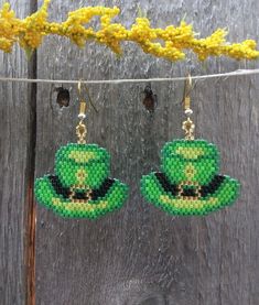 St. Patrick's Day Beaded Hat earrings, so fun to wear around St. Patrick's Day or any day if your Irish. Earrings are made with high quality Delica beads in greens, black and gold with a gold ear wire. Add a little luck of the Irish to your wardrobe and go in style! Fun and light weight to wear! 100% Handmade with my passion for beading and attention to detail. Each piece can take hours to complete one bead at a time. Length of the earrings - 1 inch by 1 inch beading without ear hook and 2 inches with ear hook Please check out the many other listings in my shop! https://barbsbeadingstudio.etsy.com Original design by Sandra Caufield at ForbesFarmGifts Handmade in the heart of Oklahoma, USA I've made every effort to get accurate photos so you can see all the details. If you still have any qu