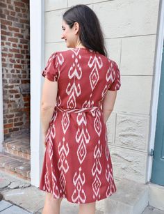 Our Merlot Organic Wrap Dress drapes beautifully on all body types, making it a fall favorite you’ll reach for again and again. This stunning burgundy wrap dress features an ikat design hand-woven from 100% cotton. The wrap silhouette cinches at the waist to create a beautiful hourglass shape, while the soft, organic fabric flows effortlessly. The tie waist allows for a customized fit that accentuates your curves, and convenient pockets add a touch of practicality. Curve-friendly and flattering Cotton Wrap Dress, Dress Drape, Organic Fabric, Ikat Design, Handwoven Fabric, Hourglass Shape, Dresses Xxl, Ikat Fabric, Retro Men