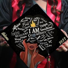 a woman holding up a graduation cap with words written all over her face on it