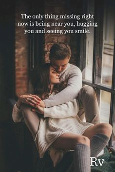 a man and woman sitting next to each other in front of a window with the words, the only thing missing right now is being near you, hugging you