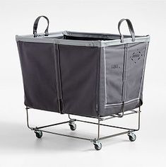 a gray shopping cart with wheels and a bag on the top, in front of a white background