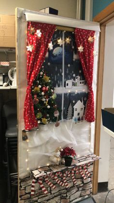 a christmas display in an office cubicle with red and white decorations on the windowsill