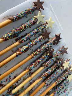 several wooden sticks with sprinkles and stars on them