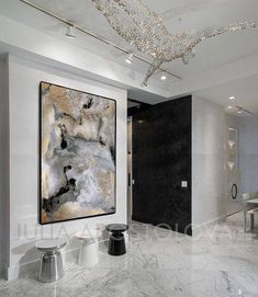 an elegant dining room with marble flooring and art work on the wall above it