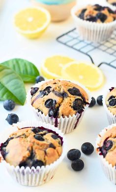 blueberry muffins with lemon slices and fresh blueberries on the counter top