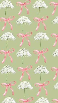 a green background with pink bows and white flowers