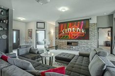 a living room filled with gray couches and chairs