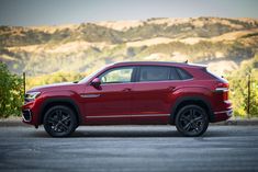 a red suv parked on the side of a road