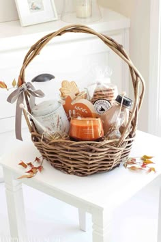 a basket filled with lots of different items on top of a white table in front of a window