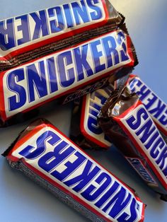 three bars of snickker candy are stacked on top of each other, with the word