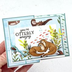 someone holding up a card that says you're otterly amazing with an animal on it