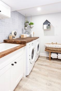 a washer and dryer in a white laundry room