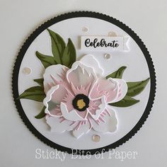 a close up of a paper plate with flowers on it and the words celebrate written in cursive writing