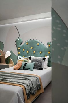 a bed with green headboard and pillows in a room that looks like a dinosaur