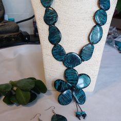 Beaitiful Tagua Seed Necklace In Blue Color With Matching Earrings. Elegant Blue Jewelry For Beach, Unique Blue Jewelry For The Beach, Handmade Blue Costume Jewelry Earrings, Handmade Blue Costume Jewelry, Handmade Blue Dangle Jewelry Sets, Adjustable Bohemian Blue Jewelry Sets, Blue Teardrop Necklace With Matching Earrings, Handmade Blue Jewelry Sets With Dangle Shape, Traditional Blue Patina Necklace