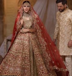 a man and woman in wedding attire standing next to each other