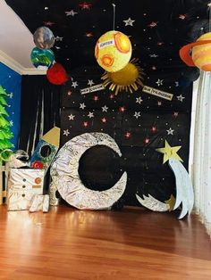 a room decorated for christmas with decorations on the ceiling and stars, moon, and crescent