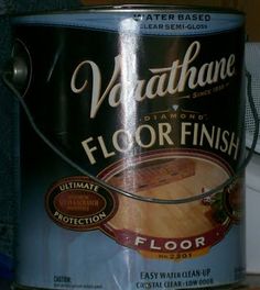 a can of wood floor finish sitting on top of a table