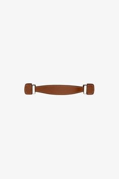 a brown belt with two metal buckles