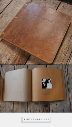 an open leather book sitting on top of a wooden table next to a photo album