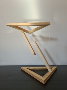 a wooden table that has been designed to look like a triangle